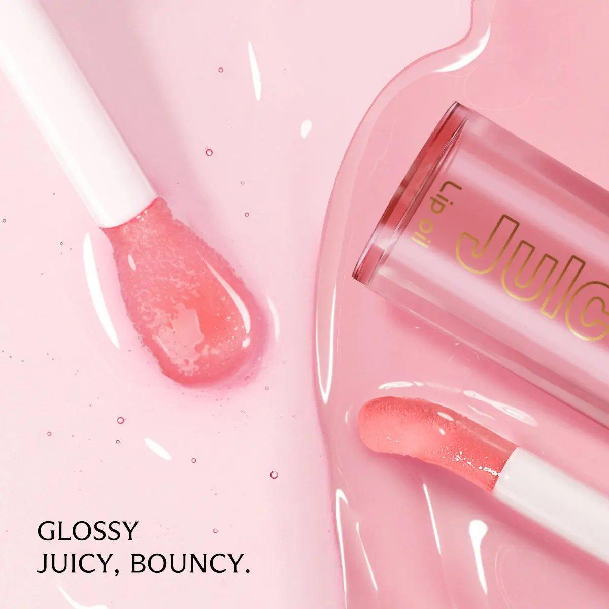 Clear pink PHOFAY Juicy Lip Oil with applicator on glossy pink surface.