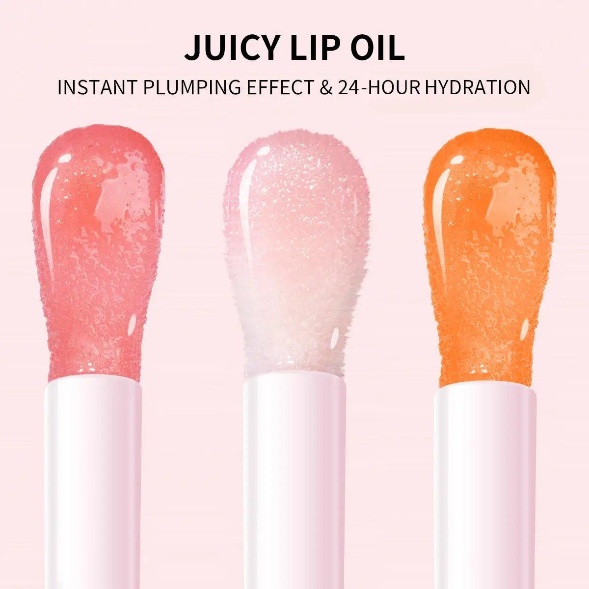 Three glossy lip oil swatches in pink, clear, and orange tones on a pale pink background.