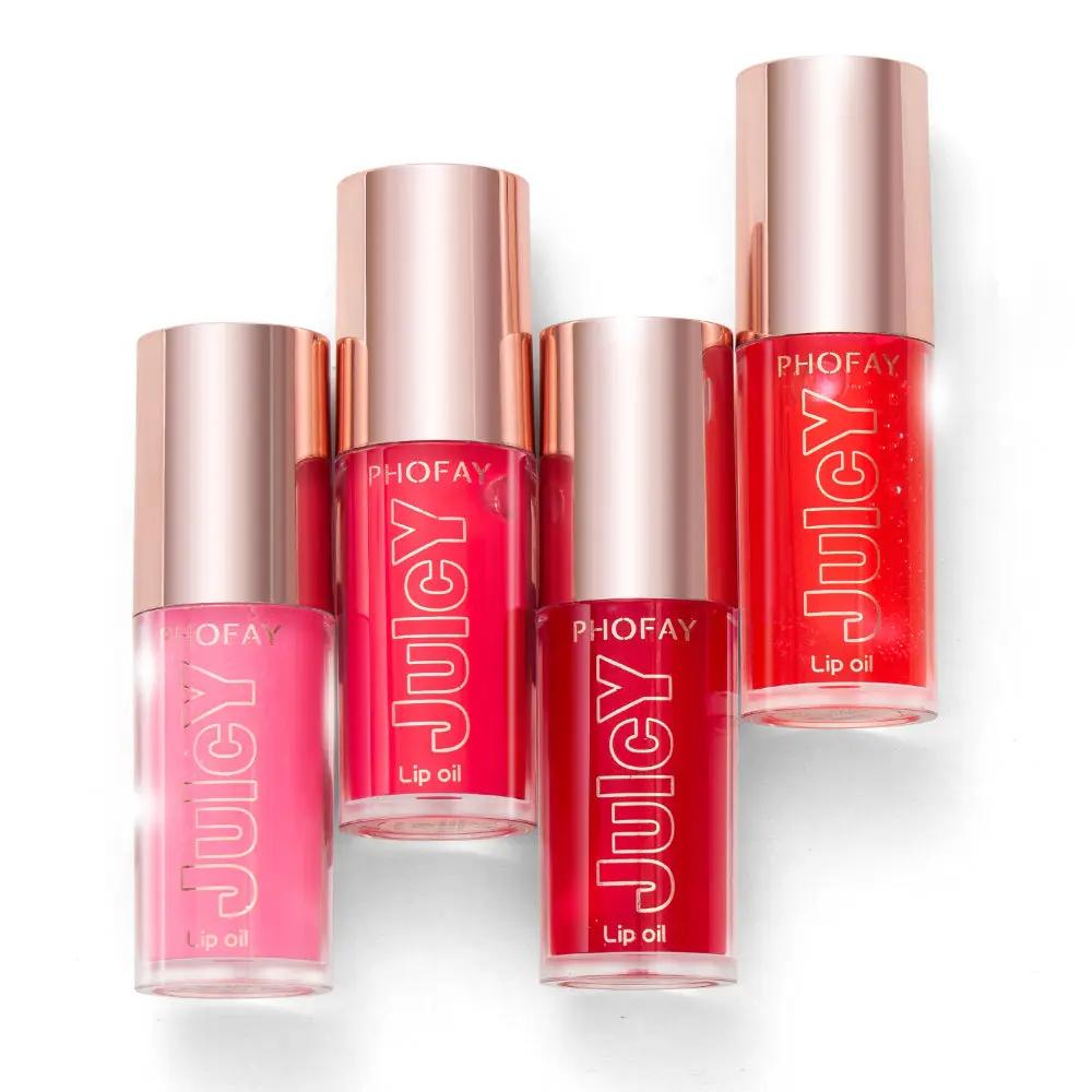 Three PHOFAY Juicy Lip Oil bottles in pink, bright red, and coral shades with rose gold caps.