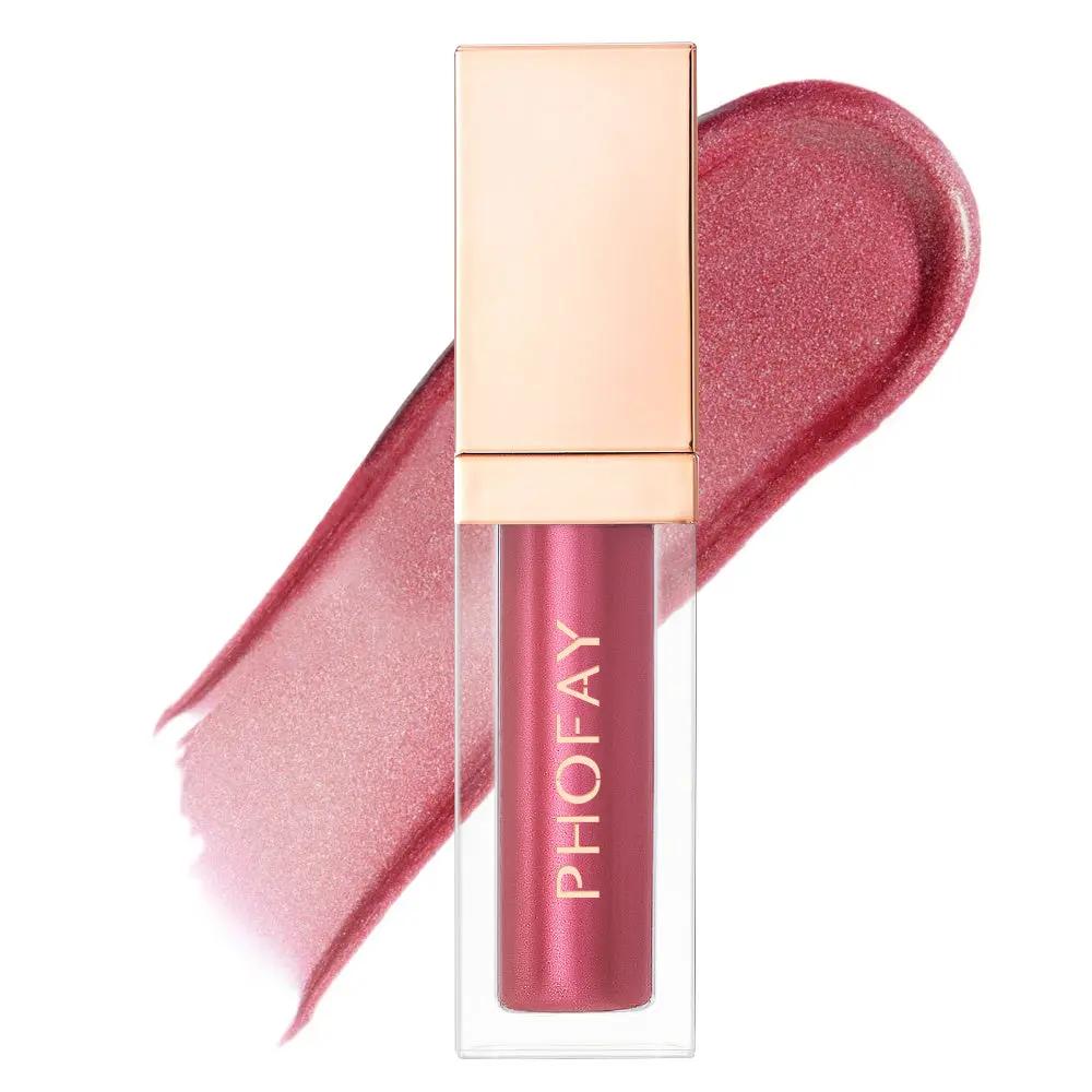Rose gold ultra-glossy lip gloss tube with reflective cap and pink shimmer swatch behind.