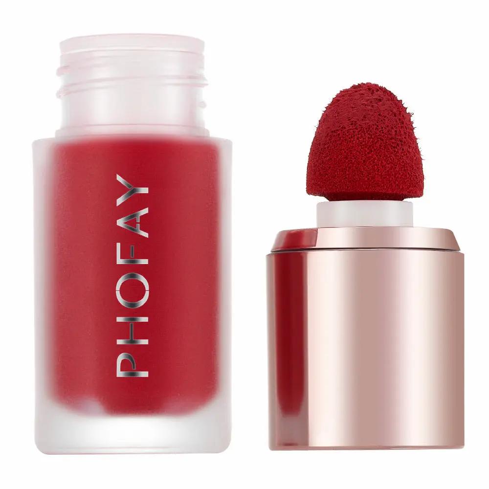 Red matte mousse liquid blush in frosted glass bottle with sponge applicator and rose gold cap.