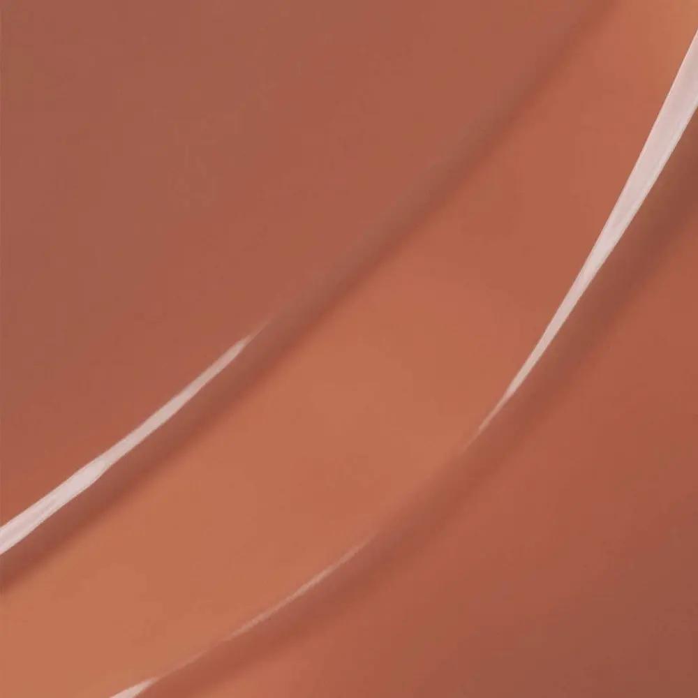 Smooth swirls of glossy, translucent peach-toned lip gloss with a glass-like shine.